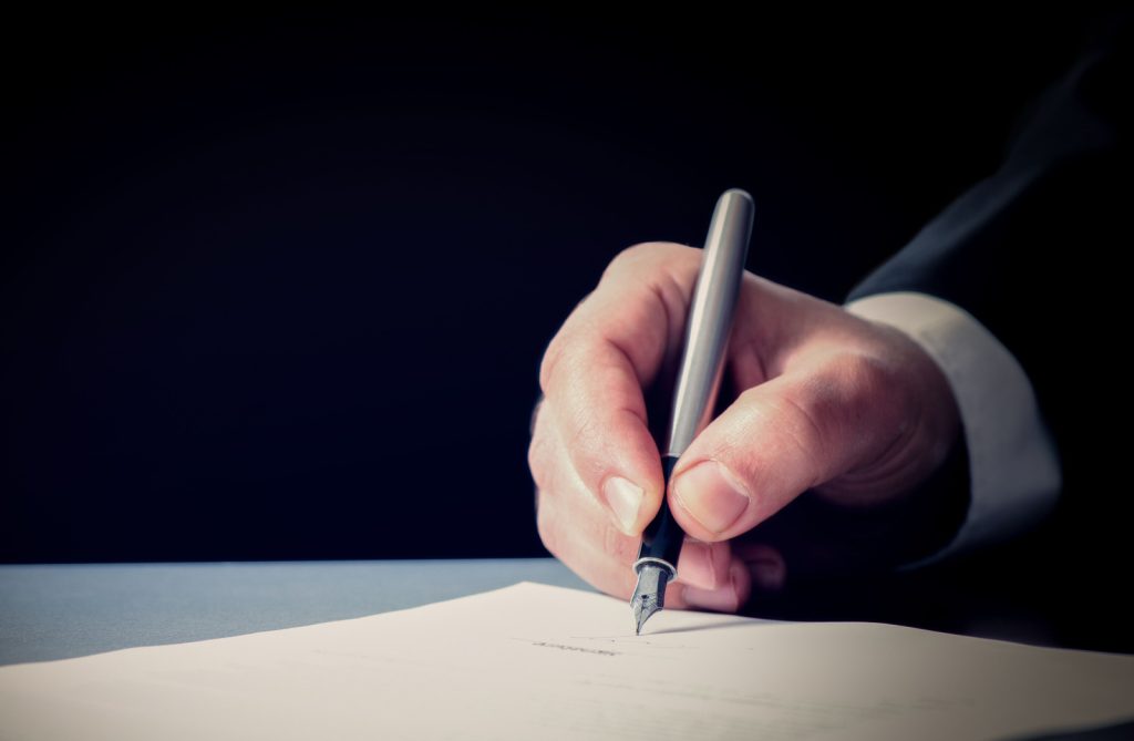 Signing Official Document Businessman Signing An Official Document
